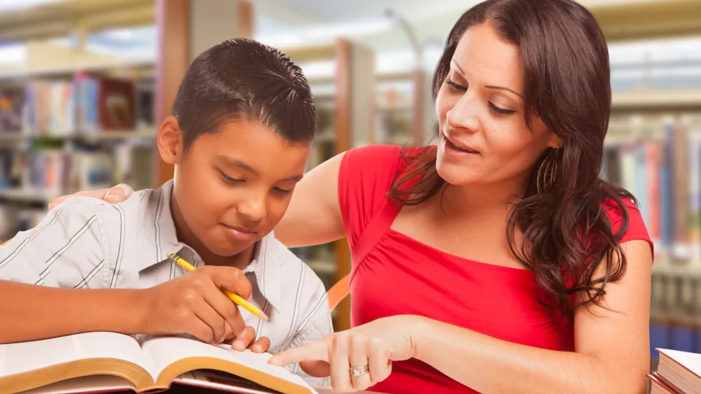 Young boy and female teacher working together